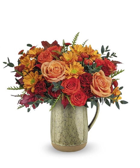 fall toned flowers in ceramic vase