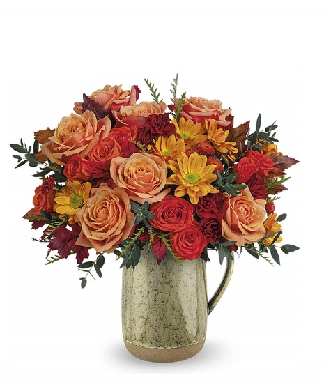 fall toned flowers in ceramic vase