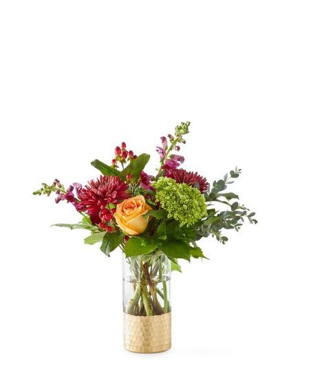 fall-toned floral arrangement with golden toned roses and deep burgundy flowers