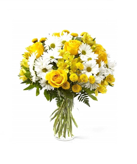 Bright yellow roses along with white daisies and greenery are presented in a classic clear vase