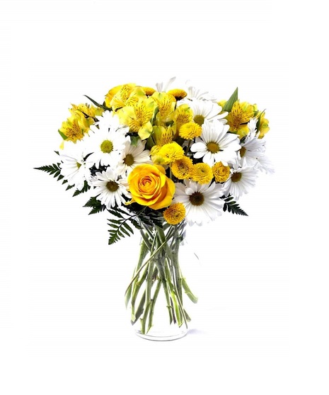 Bright yellow roses along with white daisies and greenery are presented in a classic clear vase