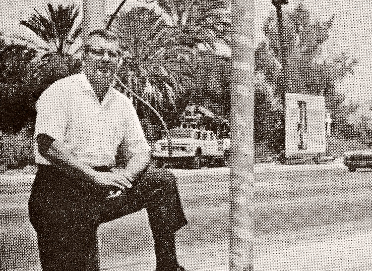 Elmer Schienbein rests his foot on the curb outside Phoenix Flower Shop, soon after becoming owner